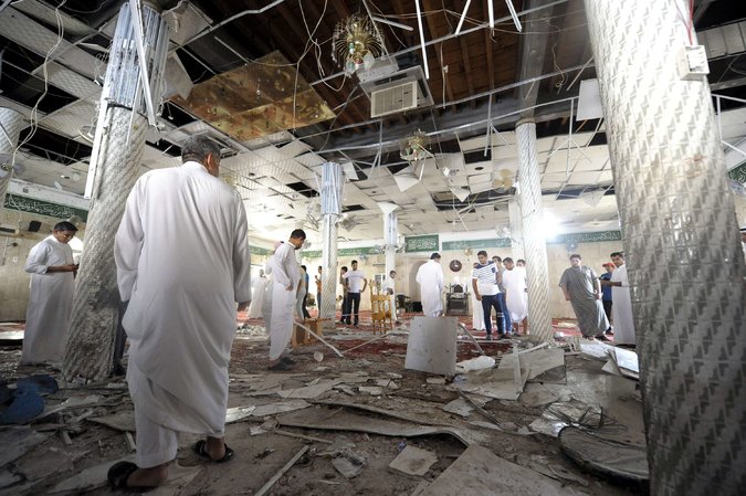 Saudi men inspected damage after a suicide bombing inside a mosque in Qatif, Saudi Arabia, on Friday. Photo: AFP — Getty Images