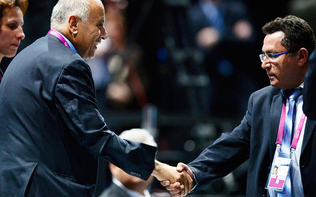 Jibril Rajoub shakes hands with Israeli soccer federation president, Ofer Eini