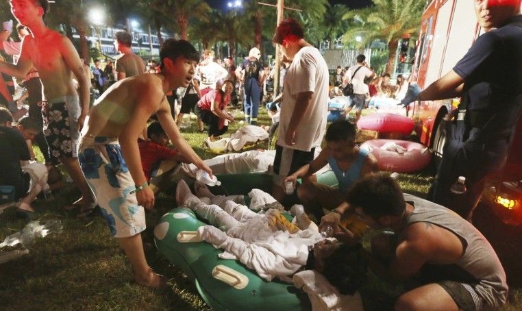 Emergency workers and partygoers tend to the injured at the Formosa Water Park. Photograph: AP