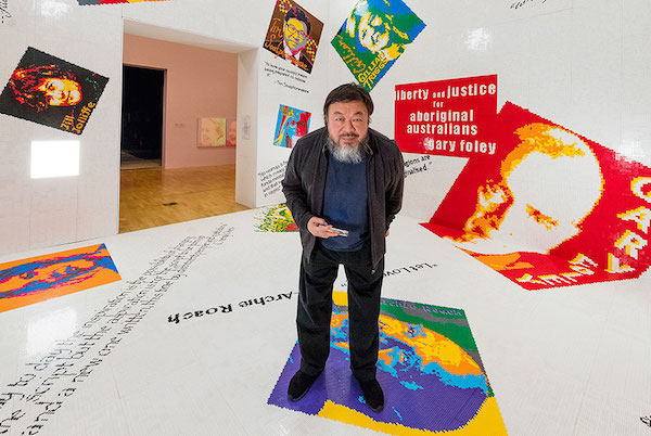 Ai Weiwei poses in his Letgo room – made of thousands of donated building bricks – at the National Gallery of Victoria.