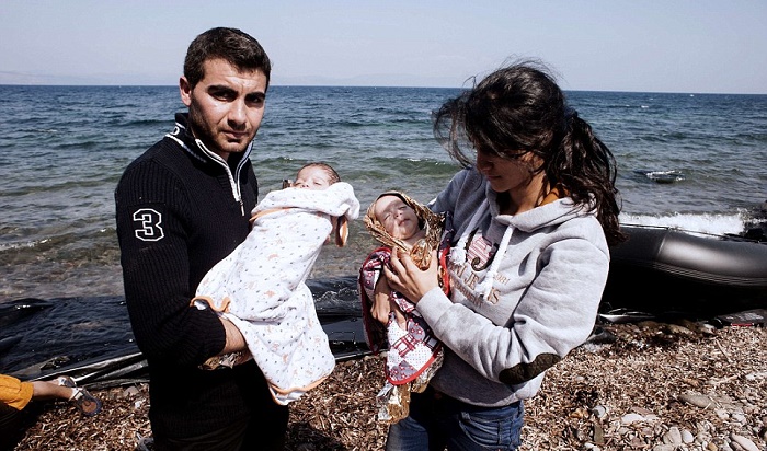 A refugee couple with their babies after safely reaching Greece