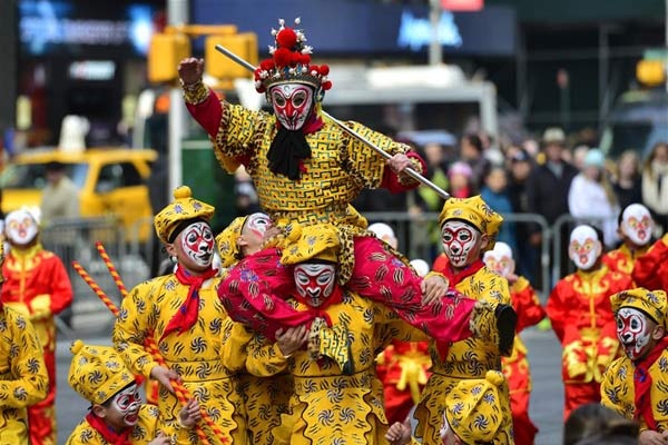 A flash mob featuring a hundred performers in monkey costumes makes an appearance to celebrate the arrival of the Chinese New Year in Times Square on Manhattan, New York, the United States, Feb. 6, 2016. (Xinhua/Wang Lei)