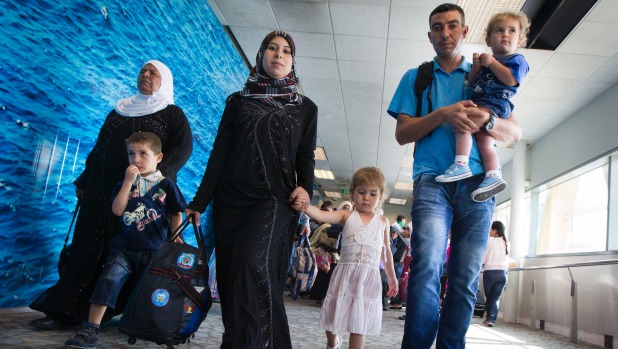 The Thani family arrived in Wellington on Friday to start their new life here. Rawad, 5, walks with his mum, Amena, and 3-year-old sister, Naba, while dad Wael carries son Salim, 2.