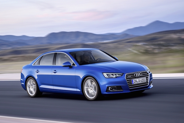 An Audi A4 in crystal effect paint finish Ara Blue is seen on the road. The 2017 Audi A4 upholds the strong tradition of its sports sedan predecessors.